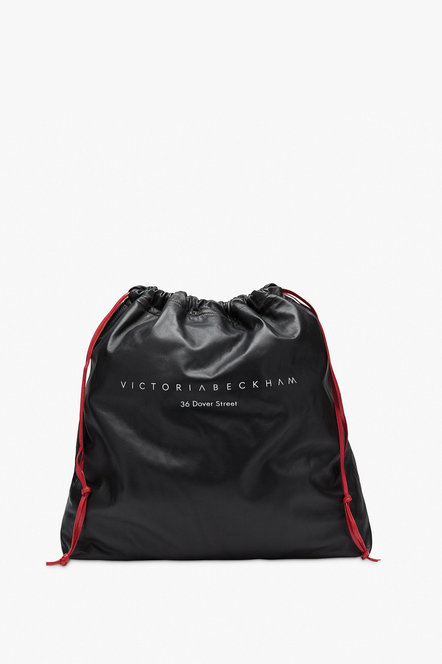 A Victoria Beckham 36 Dover St Drawstring Bag with red trim.