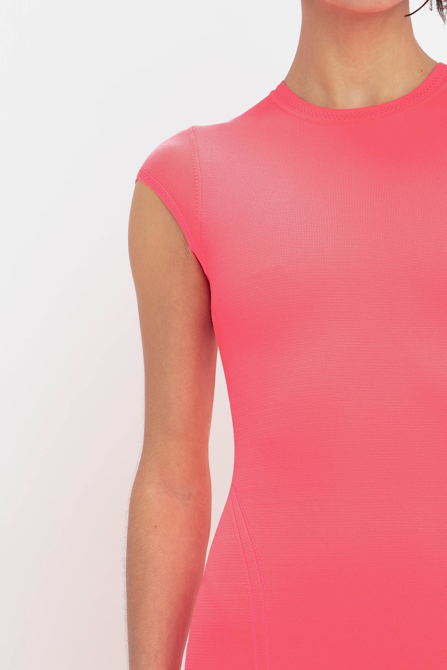 A person wearing the Victoria Beckham VB Body Compact Cap Sleeve Mini Dress in pink, shown from the shoulders to the mid-torso.