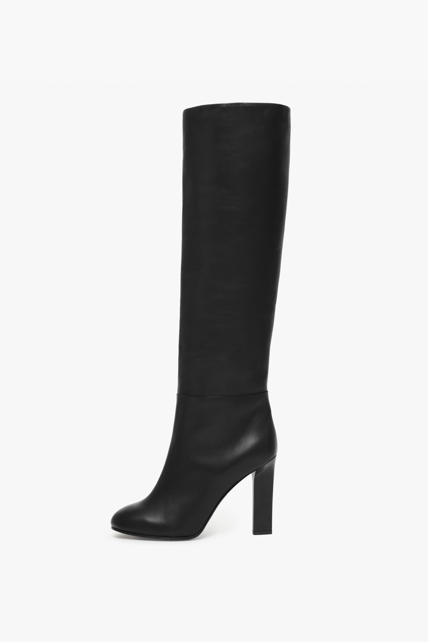 The Victoria Beckham Heel Boot is a black knee-high boot handcrafted in Italy from luxurious calf leather, featuring a high block heel, showcased side view on a white background.