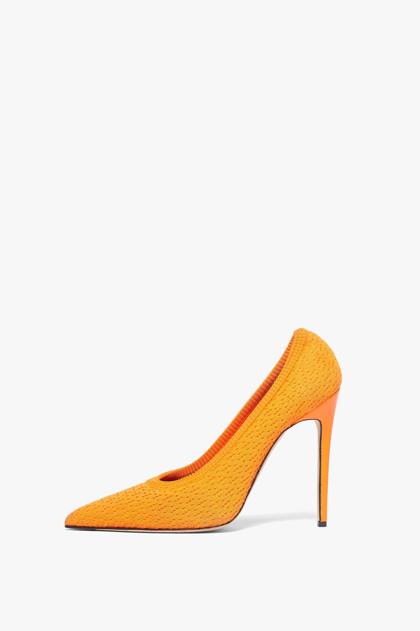 The Kristie 115MM Knit Pumps by Victoria Beckham are orange high-heeled shoes with a pointed toe and sleek stiletto heel, made from textured knit fabric, viewed from the side.
