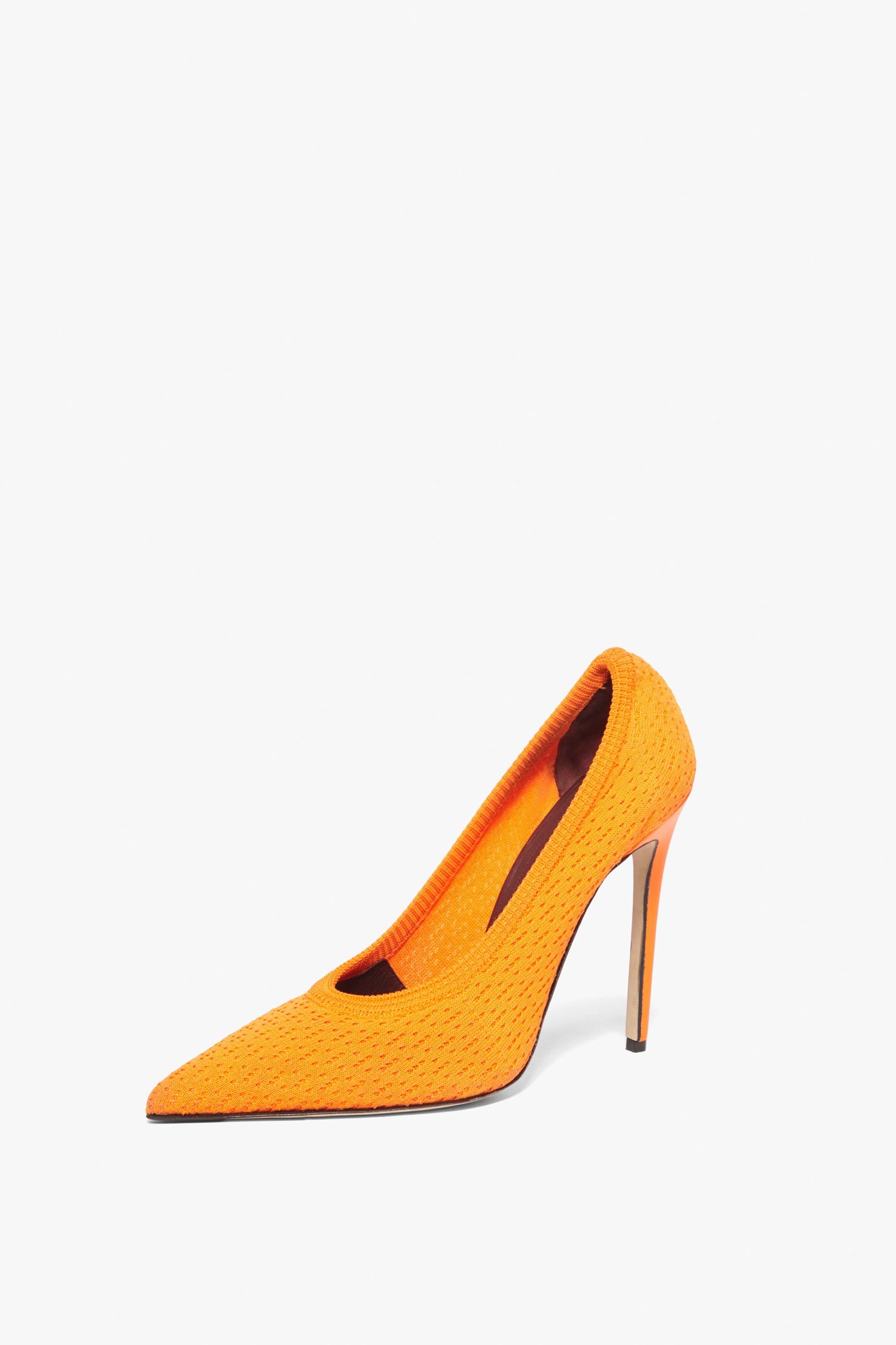 The Kristie 115MM Knit Pumps by Victoria Beckham are bright orange high-heeled shoes with a pointed toe and stiletto heel, featuring textured knit fabric and lamb leather lining, set against a white background.