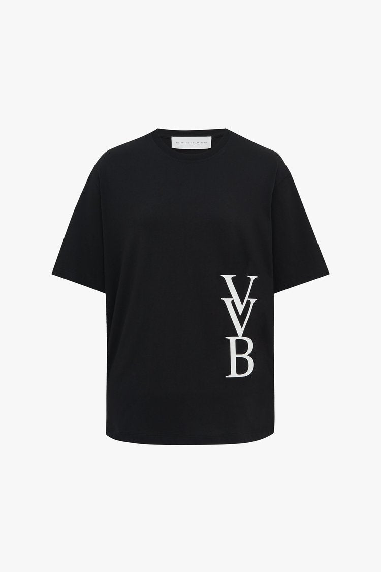 Monogram black short-sleeve t-shirt with white "VVB" letters on the lower right side. The neckline tag reads "VICTORIA VICTORIA BECKHAM," from the Victoria Beckham brand.